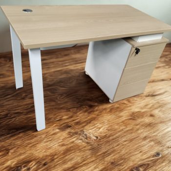 a desk with a drawer on a wooden floor
